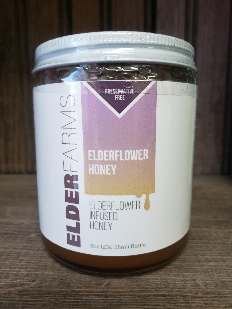 Jar of Elder Farms elderflower honey on a rustic background