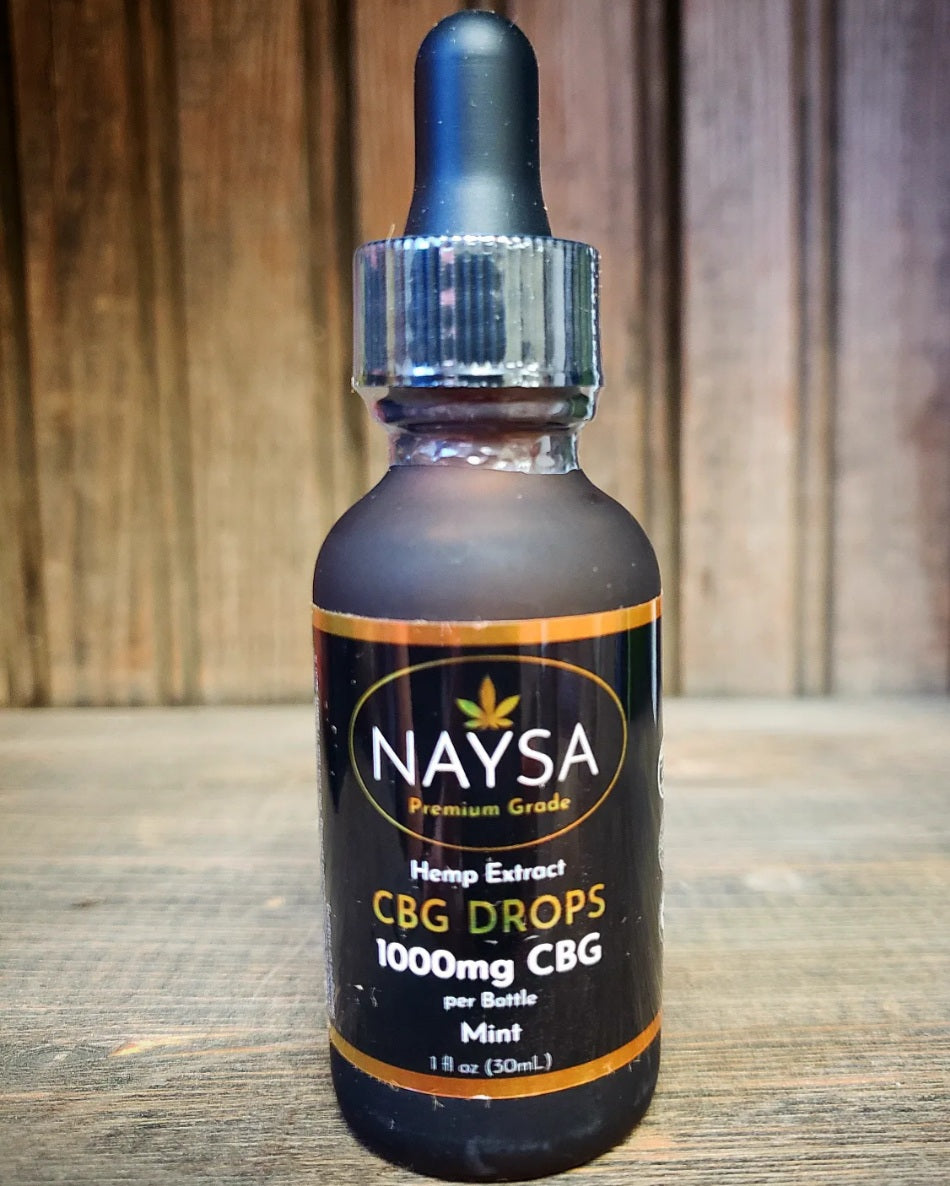 Bottle of Naysa CBG drops on a rustic background