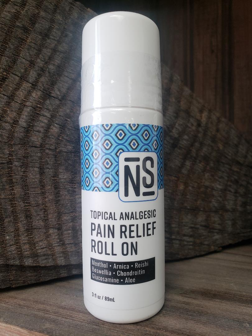 A white roll-on bottle with a blue geometric pattern, labeled as 'Topical Analgesic Pain Relief Roll On' with mentions of key ingredients like arnica, reishi, and boswellia.