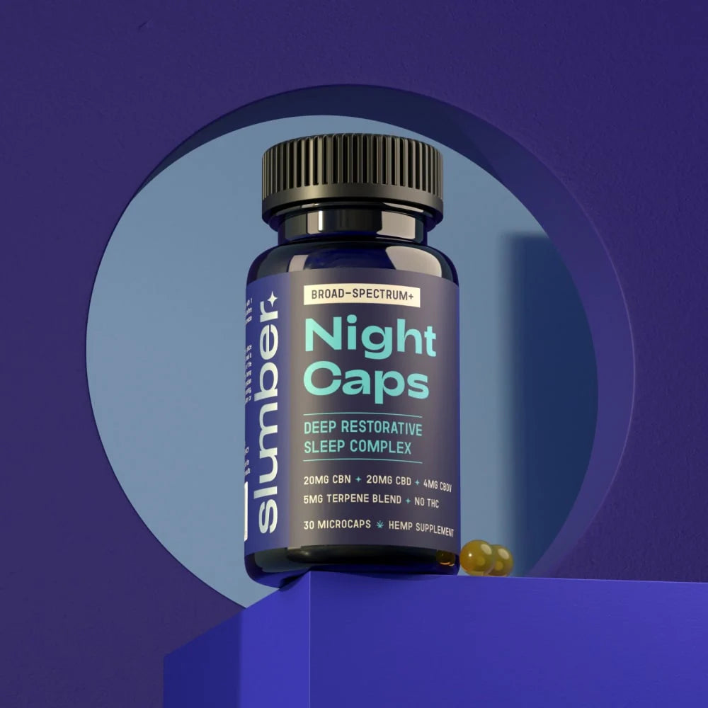 A bottle of Slumber Night Caps sleep supplements on a blue background, with the product name and details visible on the label.