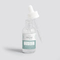 Naysa Luxe Hyaluronic Acid Serum bottle with bubbles on a light grey background