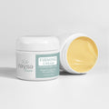 Naysa Luxe Firming Cream. 1 closed jar and one open on a light grey background